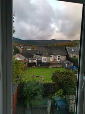a view from a window of a yard with houses at Welcome to St Helena Dunoon, a traditional villa in Dunoon