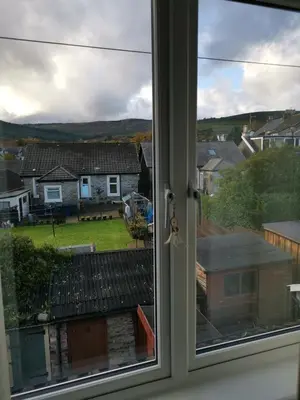 a window with a view of a house at Welcome to St Helena Dunoon, a traditional villa in Dunoon