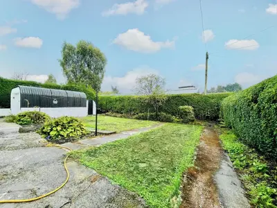 a garden with a yellow hose at Millerston House in Glasgow