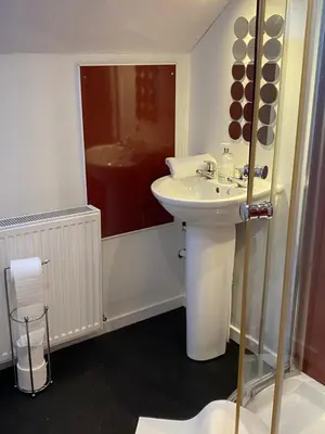 a white bathroom with a sink and a shower at Glenashdale 28 A 1/R Boyd Street Largs KA308LE in Largs
