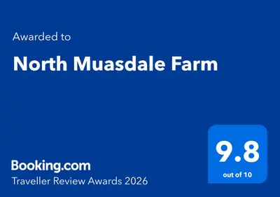 a blue sign with the words north musketale farm and the words travel review at North Muasdale Farm in Muasdale