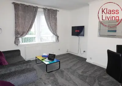 a living room with a couch and a table at Welsh Drive Apartment by Klass Living Blantyre in High Blantyre
