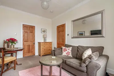 a living room with a couch and a table at amazing apartments - Torphichen Place by Haymarket in Edinburgh