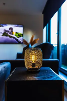 a living room with a table with a candle on it at The Skyline Suite - *Private Balcony* *Views* in Glasgow