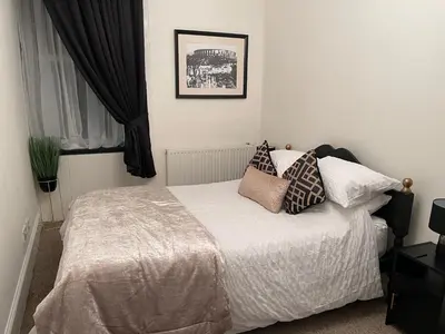 a bedroom with a bed with pillows on it at Heart of George street / Oban / Argyll in Oban