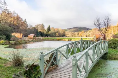 a bridge over a river next to a river at The Secret Hideaway in Penicuik