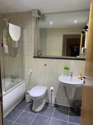 a bathroom with a toilet and a sink at City Centre 2 bedroom apartment, secure parking. in Glasgow