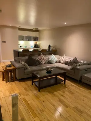 a living room with a couch and a table at City Centre 2 bedroom apartment, secure parking. in Glasgow