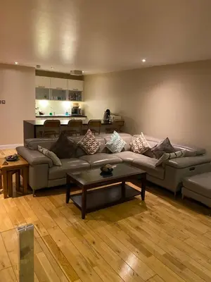 a living room with a couch and a table at City Centre 2 bedroom apartment, secure parking. in Glasgow
