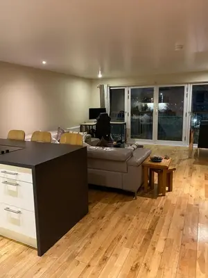 a living room with a couch and a table at City Centre 2 bedroom apartment, secure parking. in Glasgow