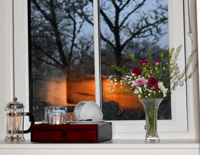 a vase of flowers sitting on a window sill at Orchy Bank House in Dalmally