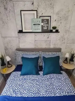a bedroom with a bed with two blue pillows at Stylish 2 bedroom Apartment / FREE Gated Parking in Glasgow