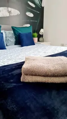a bedroom with a bed with a blue rug at Stylish 2 bedroom Apartment / FREE Gated Parking in Glasgow