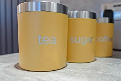 a row of three yellow thermosutes sitting on a table at Pitcorthie House in Dunfermline