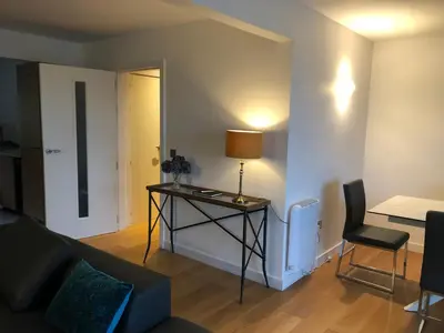 a living room with a table with a lamp on it at Tanamuir, overlooking Loch Fyne, Strachur in Cairndow
