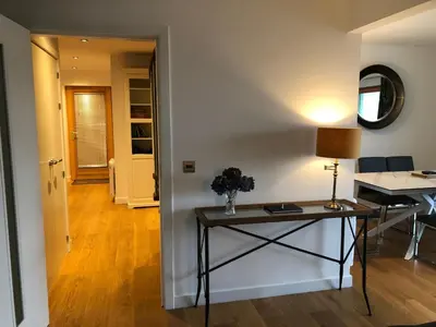 a living room with a table and a hallway at Tanamuir, overlooking Loch Fyne, Strachur in Cairndow