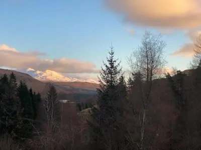 a view of a valley with mountains and trees at Ghillies Lodge Crianlarich in Crianlarich