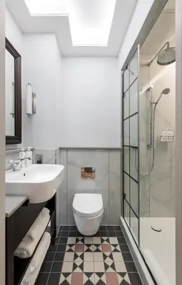 a bathroom with a sink and a toilet and a shower at RÌGH Residences - George Street in Edinburgh