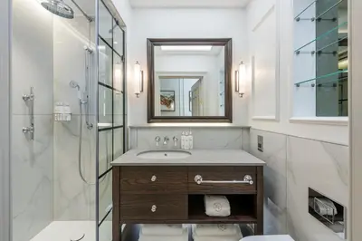 a bathroom with a sink and a shower at RÌGH Residences - George Street in Edinburgh