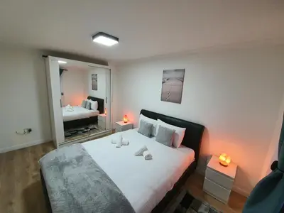 a bedroom with a large bed with a mirror at Modern house close to Glasgow Green in Glasgow