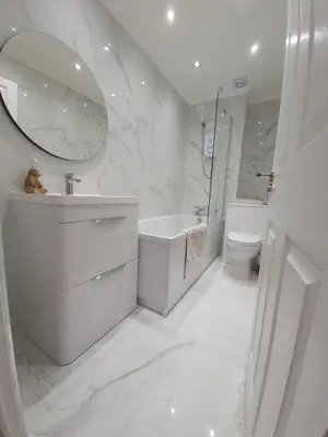 a white bathroom with a sink toilet and a mirror at Modern house close to Glasgow Green in Glasgow