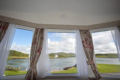 a window with a view of a river at Sunnybrae, Isle of Luing in Cullipool