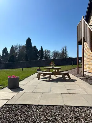 a picnic table sitting on a patio in a park at Cosy Country Modern Studio with Patio Space. in Crieff