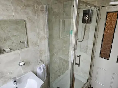 a bathroom with a shower and a sink and a shower at Snug - Abhainn Apartment in Helensburgh