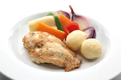 a plate of food with chicken and vegetables on it at SGE Esplanade Hotel in Dunoon
