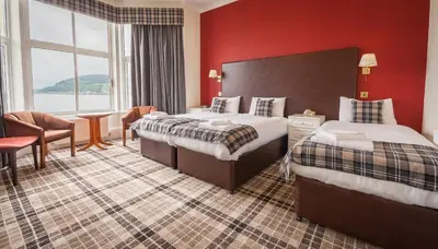 a hotel room with two beds and a large window at SGE Esplanade Hotel in Dunoon