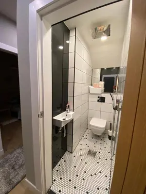a small bathroom with a sink and a toilet at Lovely 3 bed with jacuzzi, close to airport, driveway, wifi in Edinburgh