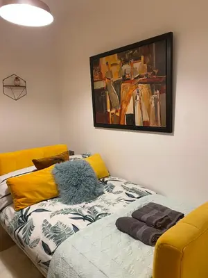a room with a bed and a painting on the wall at Lovely 3 bed with jacuzzi, close to airport, driveway, wifi in Edinburgh