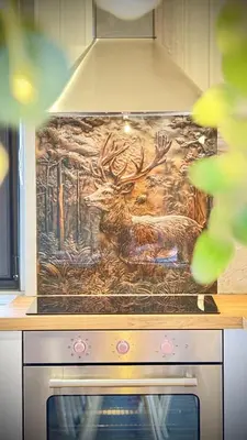 a painting of a deer on top of an oven at Luxurious mountain retreat lodge Hunters Quay in Dunoon