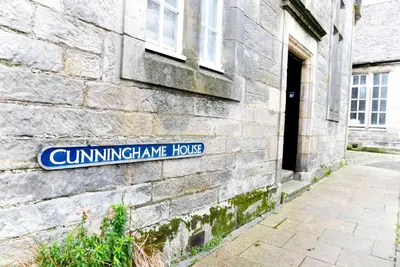 a street sign on the side of a building at Stunning & unique apt in Culross in Culross