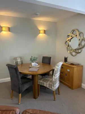a dining room with a wooden table and chairs at Menstrie Castle Stay in Stirling