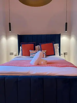 a woman laying on top of a bed at Stunning 1 bed Apt in West End in Glasgow