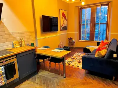 a living room with a table and a couch at Stunning 1 bed Apt in West End in Glasgow