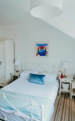 a white bedroom with a bed and a white ceiling at Dawn Break Guest House in Largs