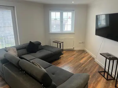 a living room with a couch and a flat screen tv at Niche View in Irvine