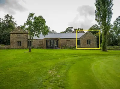 a house with a large green yard in front of it at Stunning Edinburgh 1820s stables converted studio in Edinburgh