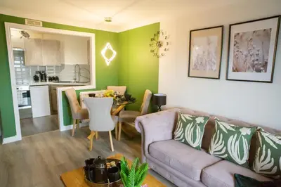 a living room with a couch and a table at The Marine - Balcony - Beach View - Coorie Doon Stays in Ayr