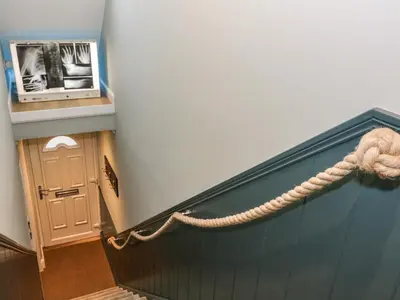 a rope is attached to a wall in a room at Feus Holiday Cottage in Auchterarder