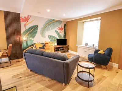 a living room with a couch and two chairs at Feus Holiday Cottage in Auchterarder