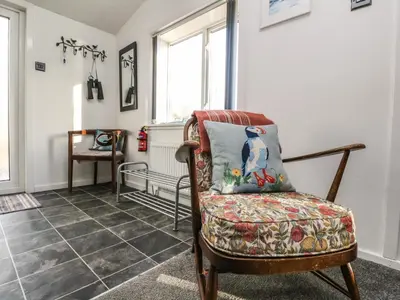 a room with a chair with a pillow on it at Kelpie in Lochgilphead