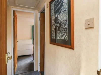 a hallway with a picture hanging on a wall at Kelpie in Lochgilphead