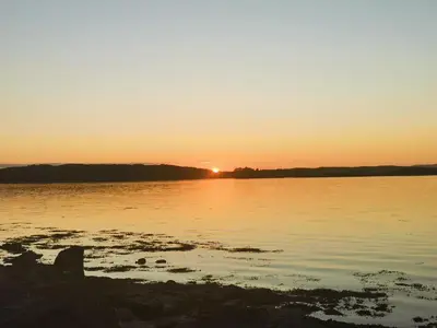 a sunset over a body of water at Kelpie in Lochgilphead