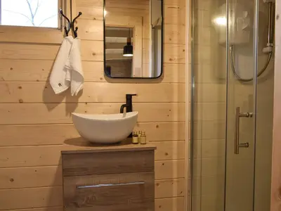 a bathroom with a sink and a shower at Pinewood Cabin in Saline