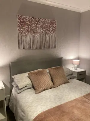 a bedroom with a bed with two pillows on it at Machrie Cottage, Oban, in Oban