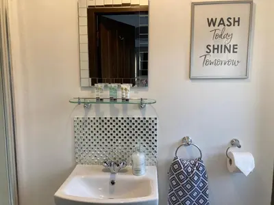a bathroom with a sink and a mirror at Machrie Cottage, Oban, in Oban