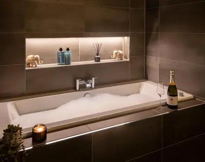 a bathroom with a bath tub with a bottle of wine at Station View, Dunblane in Dunblane